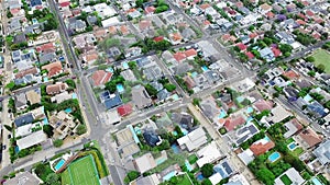 Aerial drone, city and road with architecture or traffic in urban settlement above houses or buildings. Top view of