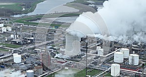 Aerial drone close up view on a smoke stack at a chemical park production of plastics. Heavy industrial zone in