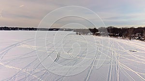 Aerial drone crane view going backward revealing the winter scenery on the frozen river in Laval-Ouest-24fps