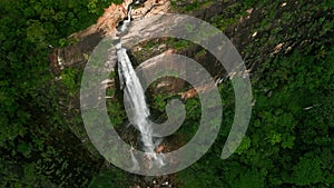 Aerial drone Diyaluma Falls, as water cascades down amid green plants in Sri Lanka mountains, hidden gem for adventure