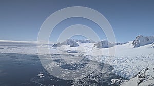 Aerial drone flight over Antarctica shoreline.