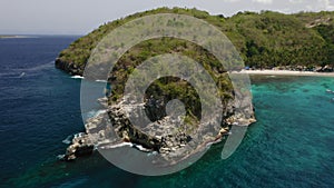 Aerial drone flight over tiny island near beach, Bali, Indonesia, 4k.