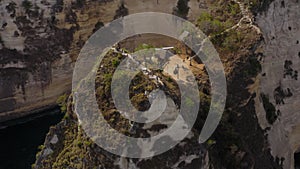 Aerial drone flight over treehouses at Atuh cliff at Nusa Penida island, Bali, Indonesia, 4k