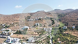 Aerial drone flight towards dry mountain landscape with few houses located on the hill in Tinos,Greece