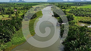 Aerial drone fly back and tilt up revealing canal and traditional fishing trap