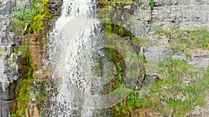 Aerial Drone Flying Down Short Rocky Mountain Waterfall