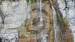 Aerial Drone Flying Up Tall Rocky Mountain Waterfall