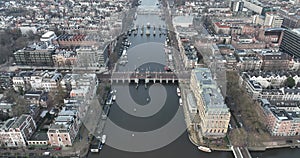 Aerial drone footage of the Amstel river and De Hogesluis Brug 246 in Amsterdam East and city center downtown. Dutch