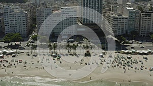 Aerial, drone footage of car and pedestrian traffic on Copacabana Beach