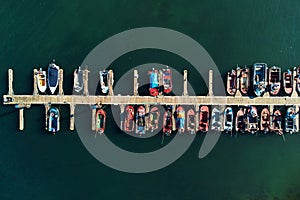 Aerial drone footage of fishing boats moored at the marina.