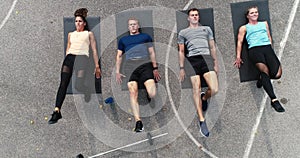 Aerial, drone footage of group of well-trained men and women doing exercises
