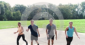 Aerial, drone footage of group of well-trained men and women doing exercises