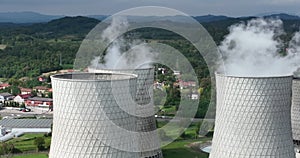 Aerial drone footage of a large coal power plant station with cooling towers chimney and boiler house in an air