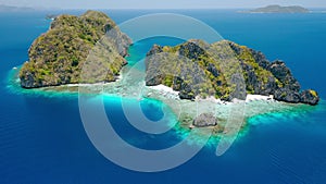 Aerial drone footage of Shimizu Island from distance in El Nido, Palawan, Philippines. Rocks and crystal clear turquoise