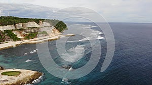 Aerial drone footage of the waves crashing on the Melasti beach, Bali