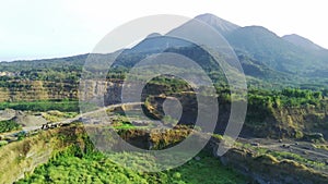 Aerial drone glides over an abandoned mine, capturing the eerie beauty of nature reclaiming manmade structures in Ranu