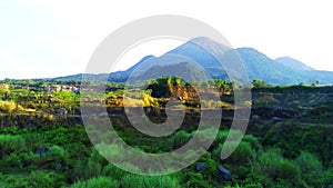 Aerial drone glides over an abandoned mine, capturing the eerie beauty of nature reclaiming manmade structures in Ranu