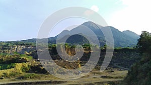 Aerial drone glides over an abandoned mine, capturing the eerie beauty of nature reclaiming manmade structures in Ranu