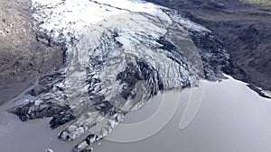 Aerial drone high angle view of the melting Solheimajokull glacier in Iceland. Climate change, melting glaciers, global warming