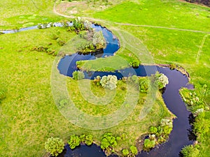 Aerial drone landscape of river in green field