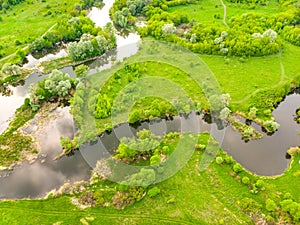 Aerial drone landscape of river in green field