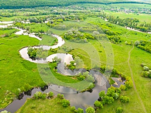Aerial drone landscape of river in green field