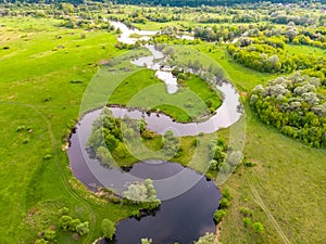 Aerial drone landscape of river in green field