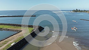 Aerial drone motion towards tthe ocean along the river Anahulu in Haleiwa on Oahu