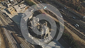 Aerial Drone over cement factory. Trucks loading and pouring sand. Building Industrial footage