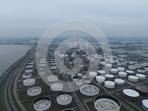 Aerial drone overview view on refinery in the port of Antwerp. Processing of fossil fuels. Petroleum industry at dusk