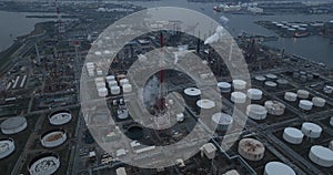 Aerial drone overview view on refinery in the port of Antwerp. Processing of fossil fuels. Petroleum industry at dusk