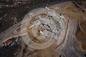 Aerial drone panorama of an open mine or quarry on a sunny day at Verd, Slovenia. Visible terraces and vast surface of sand and photo