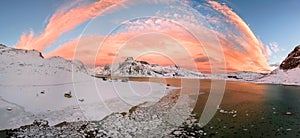 Aerial drone panorama photo. Beautiful sunset over the mountains and sea of the Lofoten Islands. Reine, Norway. Winter landscape w