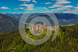 Aerial drone panorama of Steinschloss castle ruins rising above the mura valley in styria, Austria. Medieval ruins in Austria on a
