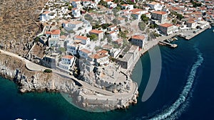 Aerial drone panoramic photo of the picturesque port and main village of Hydra or Ydra island at sunset. Hydra is a top tourist