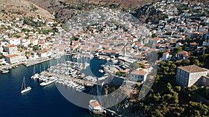 Aerial drone panoramic photo of the picturesque port and main village of Hydra or Ydra island at sunset. Hydra is a top tourist