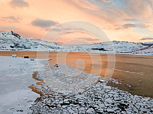 Aerial drone panoramic view. Beautiful sunset over the mountains and sea of the Lofoten Islands. Reine, Norway. Winter landscape w