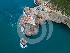 Aerial drone panoramic view of the lighthouse and cliffs at Cape St. Vincent at sunset. Algarve seascape.  Amazing landscape.Conti