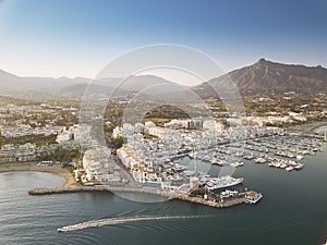 Aerial drone perspective of beautiful sunset over luxury Puerto Banus Bay in Marbella, Costa del Sol.