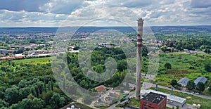 Aerial drone perspective view on high concrete chimney in heating plant close to the city