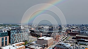 Aerial drone photo of Coors Field in Denver with rainbow over city