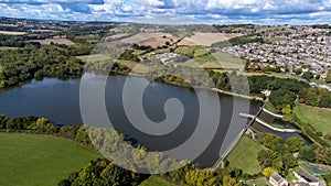 Aerial drone photo of the large Worsbrough reservoir in the village of Worsbrough, Barnsley in Sheffield in the UK, showing the