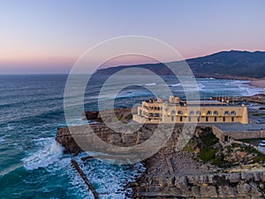 Aerial drone photo of Praia do Guincho Beach and Hotel Fortaleza at sunset in Sintra, Portugal photo