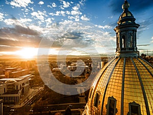 Aerial Drone Photograph - Stunning golden sunset over the Colorado state capital building & Rocky Mountains, Denver Colorado.