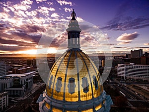 Aerial Drone Photograph - Stunning golden sunset over the Colorado state capital building & Rocky Mountains, Denver Colorado.