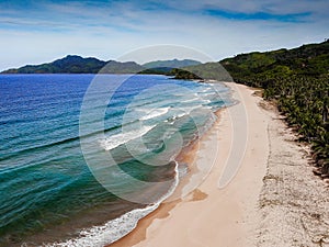 Aerial drone picture of paradise tropical beach- Nacpan, El Nido, Palawan, Philippines. Amazing beach view to coast and ocean with