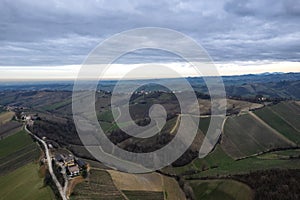 aerial drone scenic of hills, vineyards and farms in Martani near Castell'Arquato in Arda Valley, Italy.