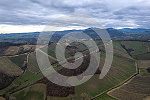 aerial drone scenic of hills, vineyards and farms in Martani near Castell'Arquato in Arda Valley, Italy.