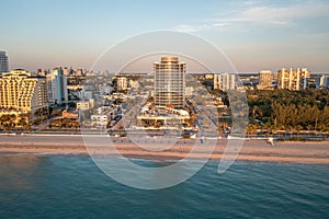 Aerial drone shoot in florida tropical coast showcasing commercial areas, blue sky and beach