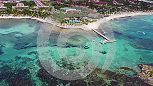 Aerial drone shot. Aerial view from above, birde eye view at an luxury resort hotel beach of a tropical coast. Turquoise